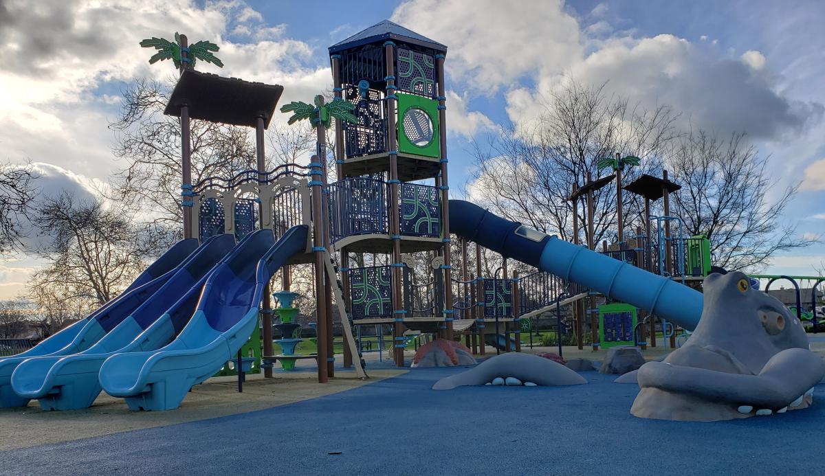 Playground featuring blue and green equipment.